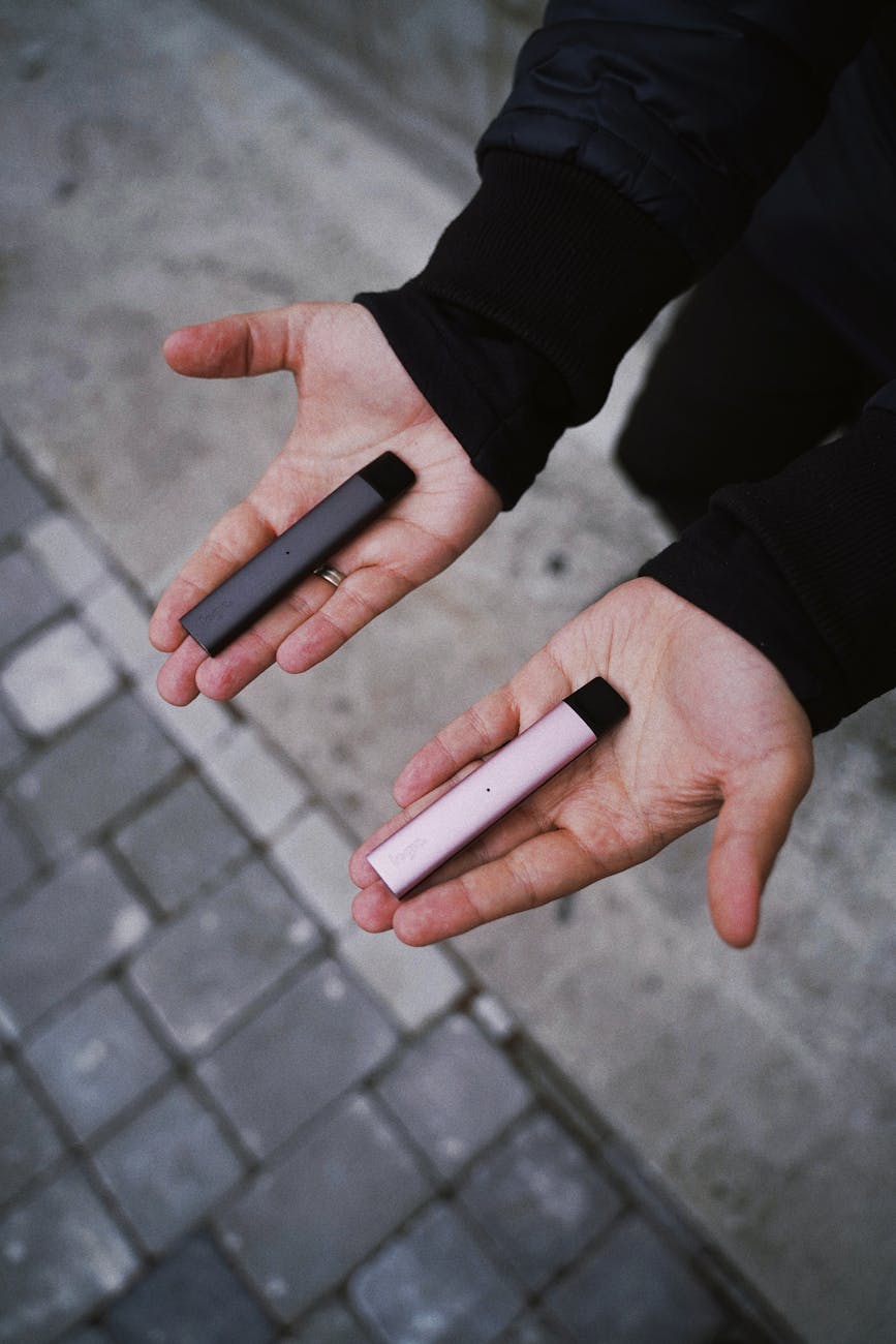 man holding logic vape pens in hands