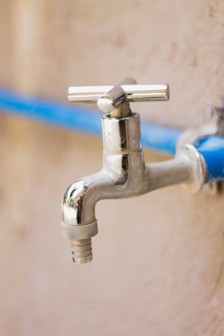 faucet connected with blue pipe