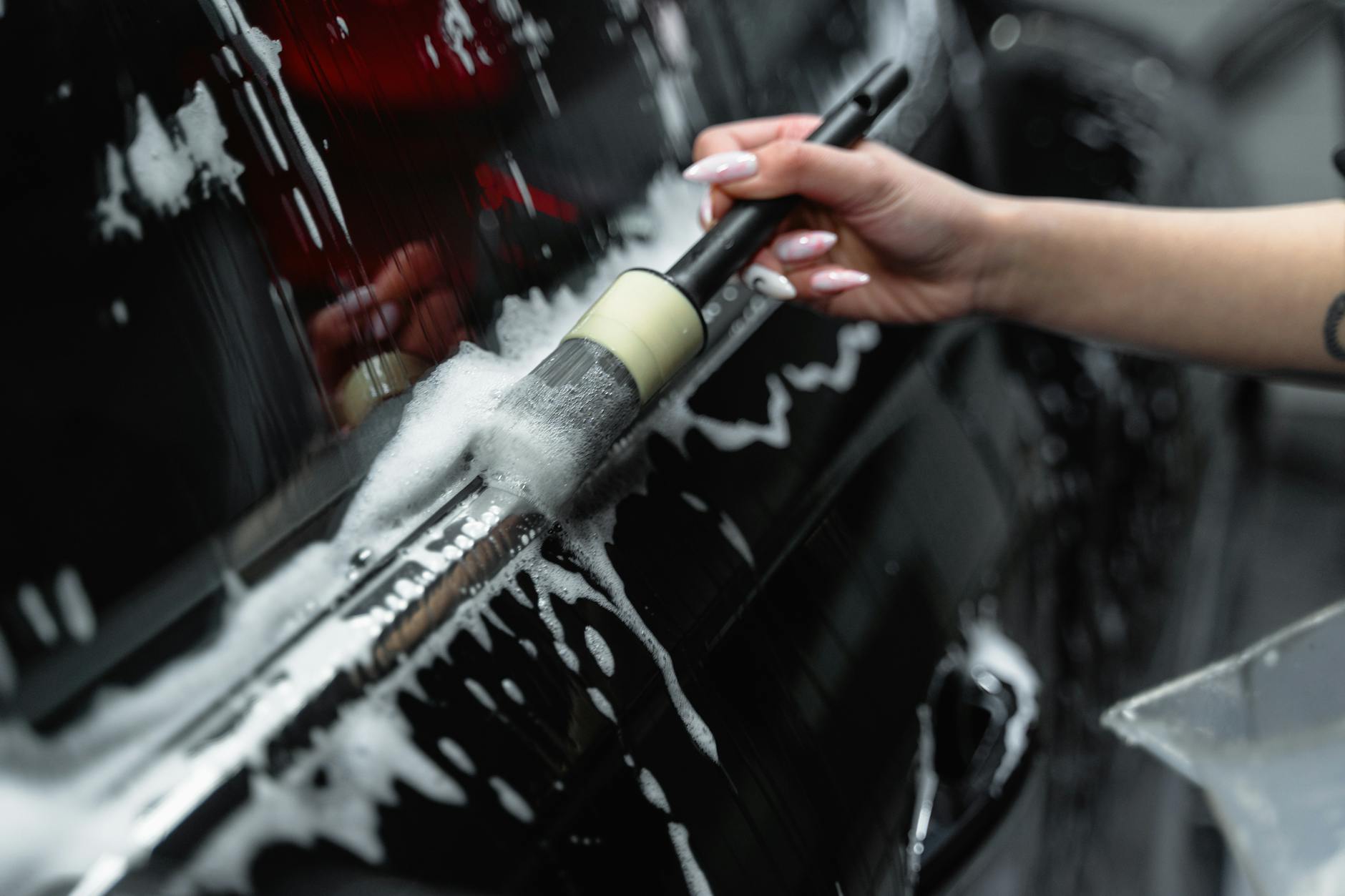 a close up shot of a person brushing a car