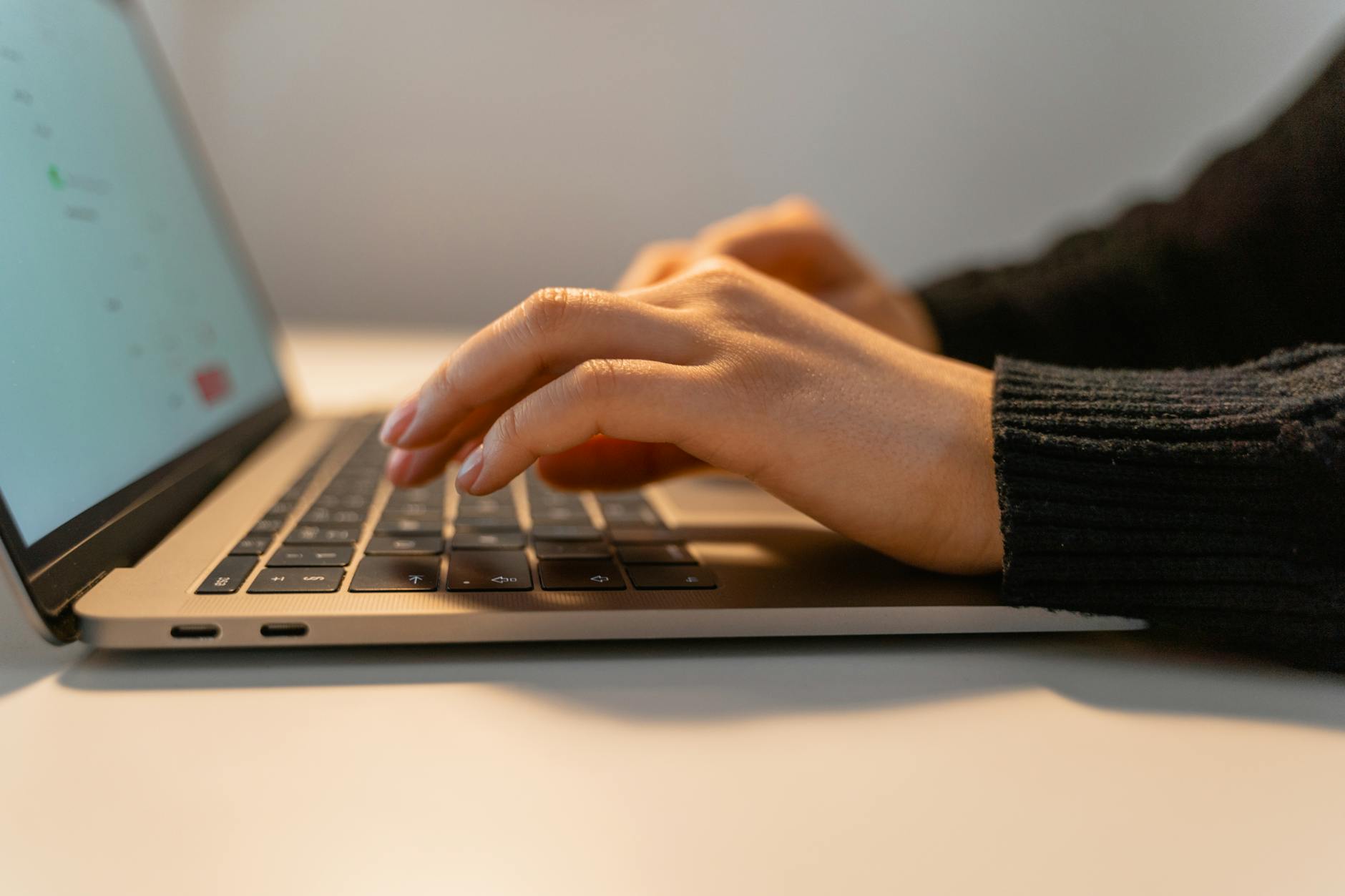 a person typing on a laptop